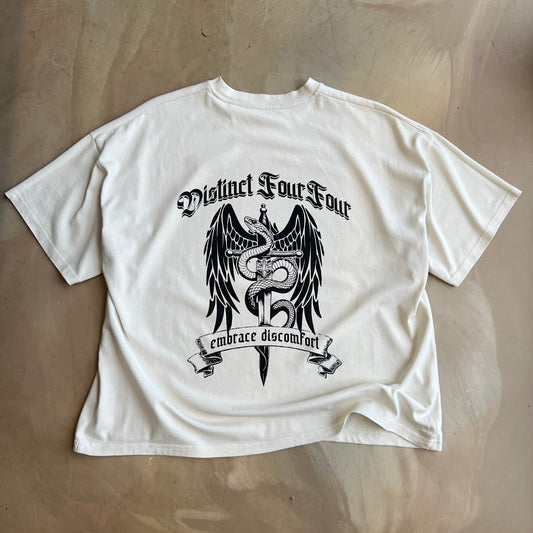 Vintage White t-shirt with black graphic design on a concrete surface