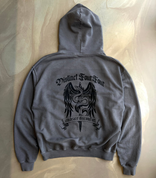 Pigment Grey hoodie with grahpic design and text on a concrete background