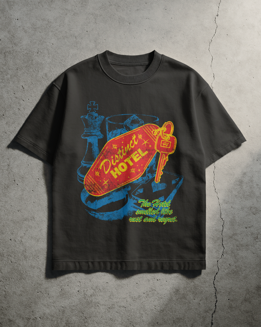 Vintage Black t-shirt with colorful graphic design on a concrete surface