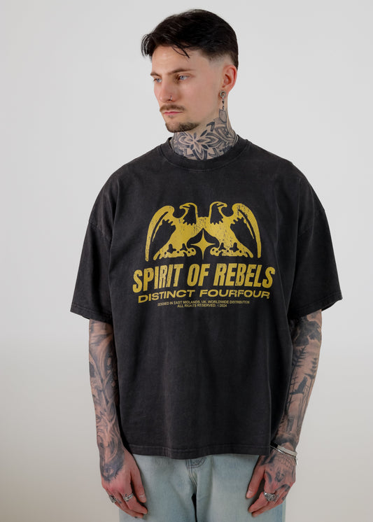 Person wearing a vintage black t-shirt with yellow graphic and text on a plain background