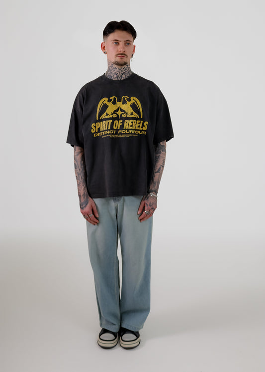 Person wearing a black t-shirt with yellow graphics and text on a white background