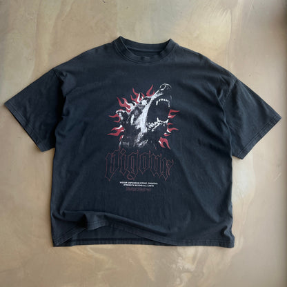 Vintage Black t-shirt with a graphic design on a concrete surface