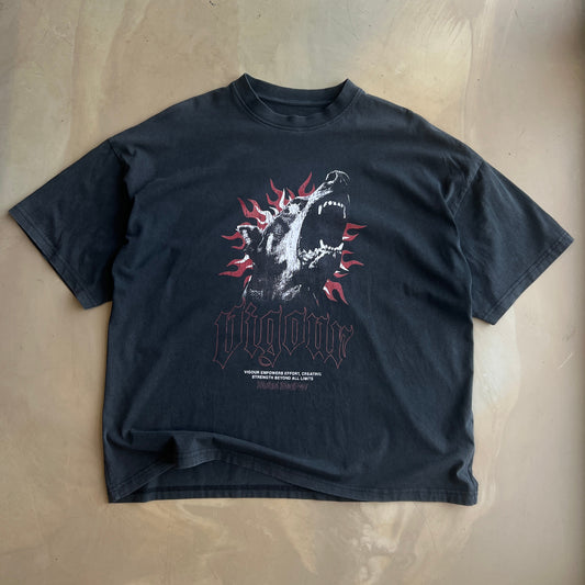 Vintage Black t-shirt with a graphic design on a concrete surface