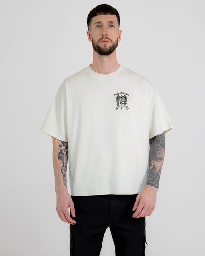 A male model wearing a white short-sleeved T-shirt with a graphic print in the center, standing against a plain background.