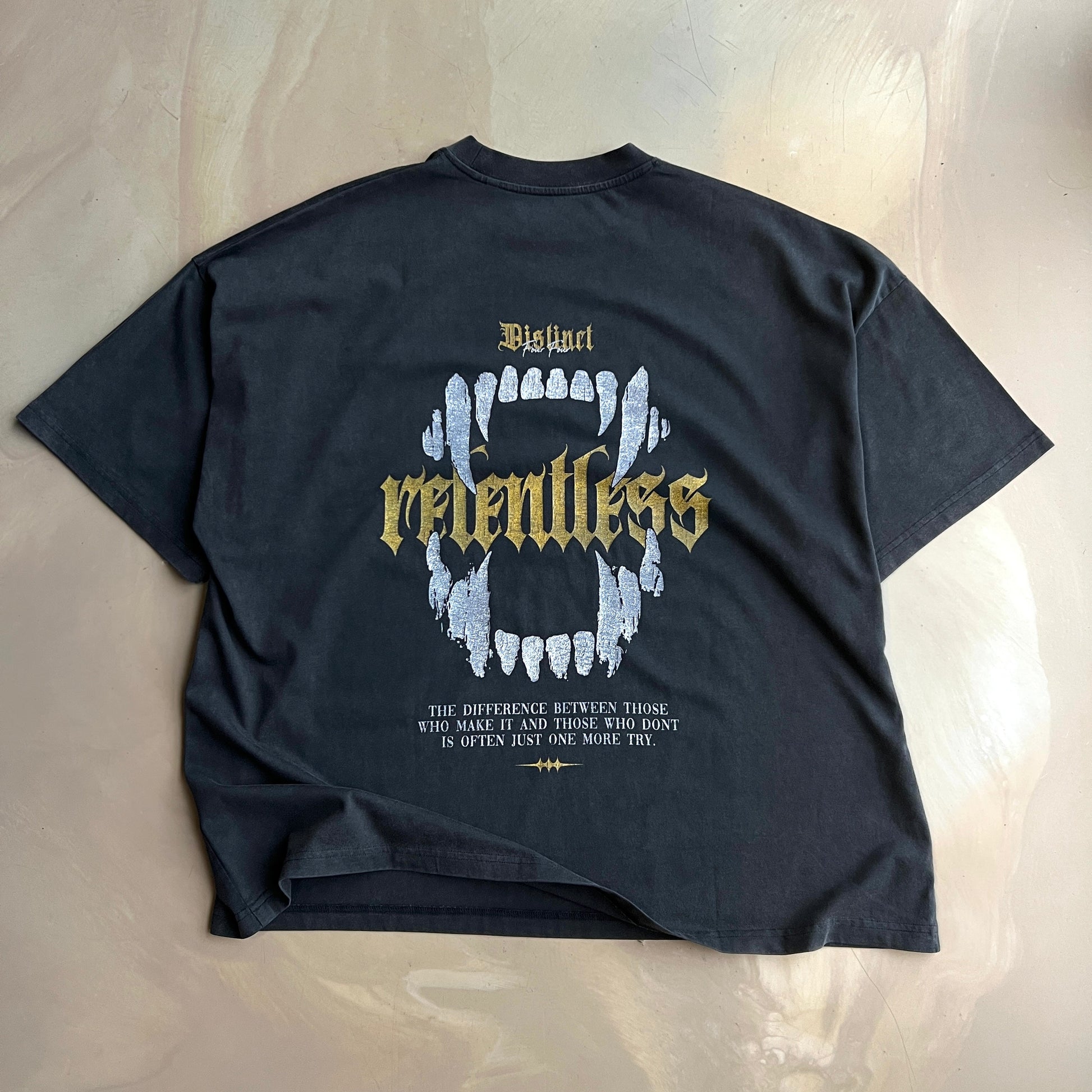 Vintage Black t-shirt with graphic design and text on a concrete background