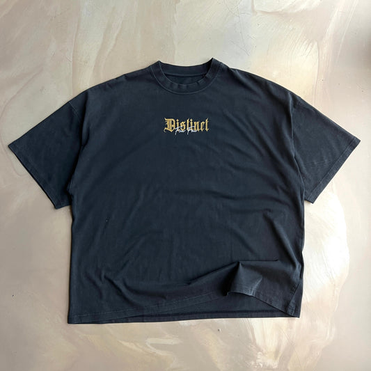 Vintage Black t-shirt flat lay on a concrete floor 