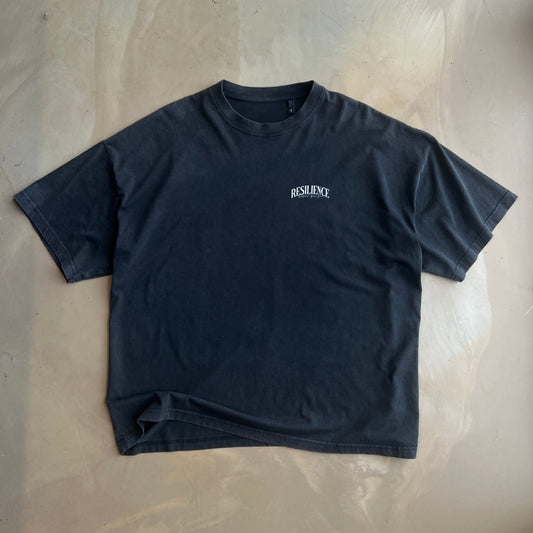 Vintage Black short-sleeve shirt with a brand logo on a concrete surface