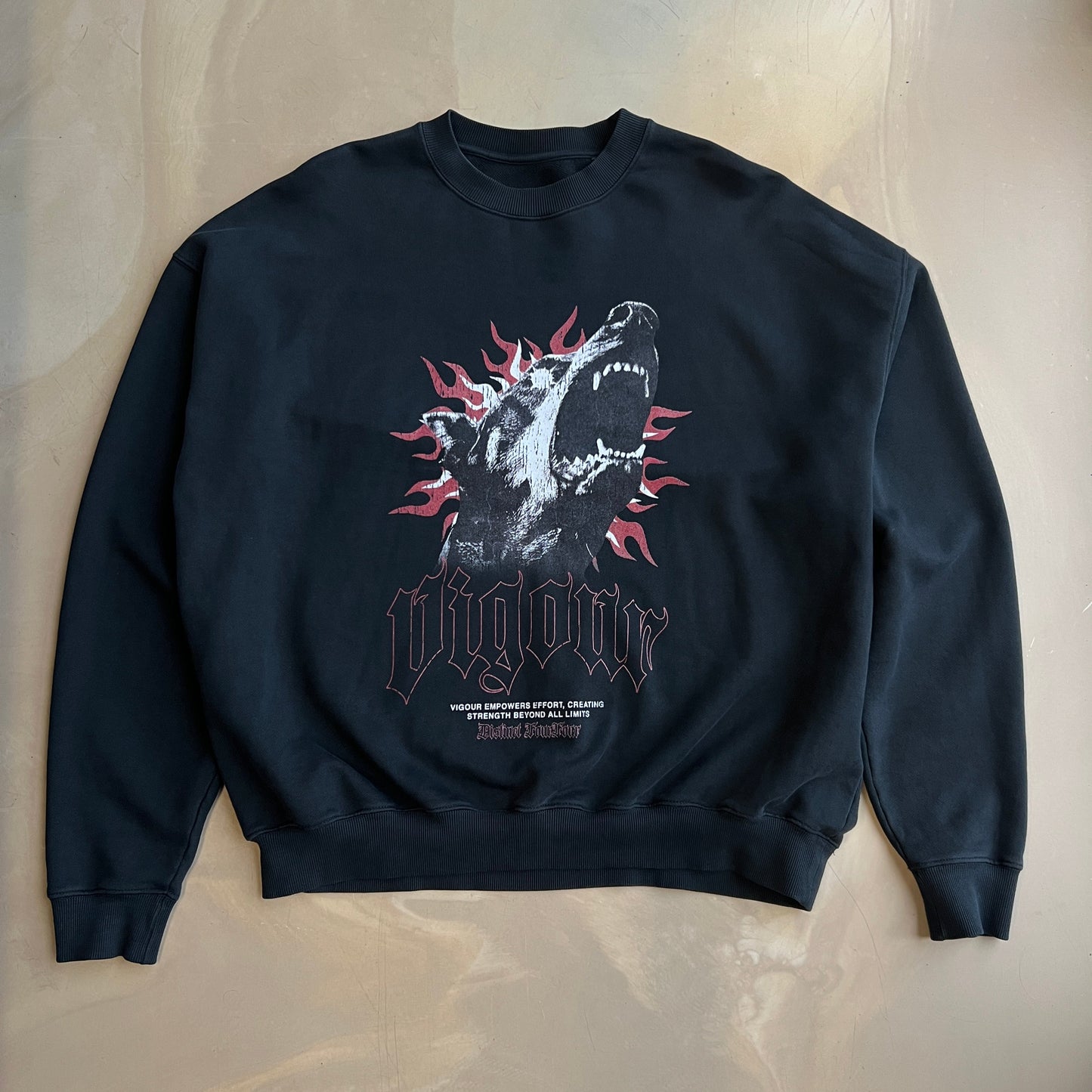 Vintage Black long-sleeve sweater with graphic design on a concrete surface